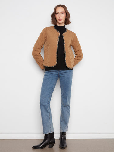 Elegant quilted jacket showcasing patch pockets for practicality and style in one piece. By Charlie B.