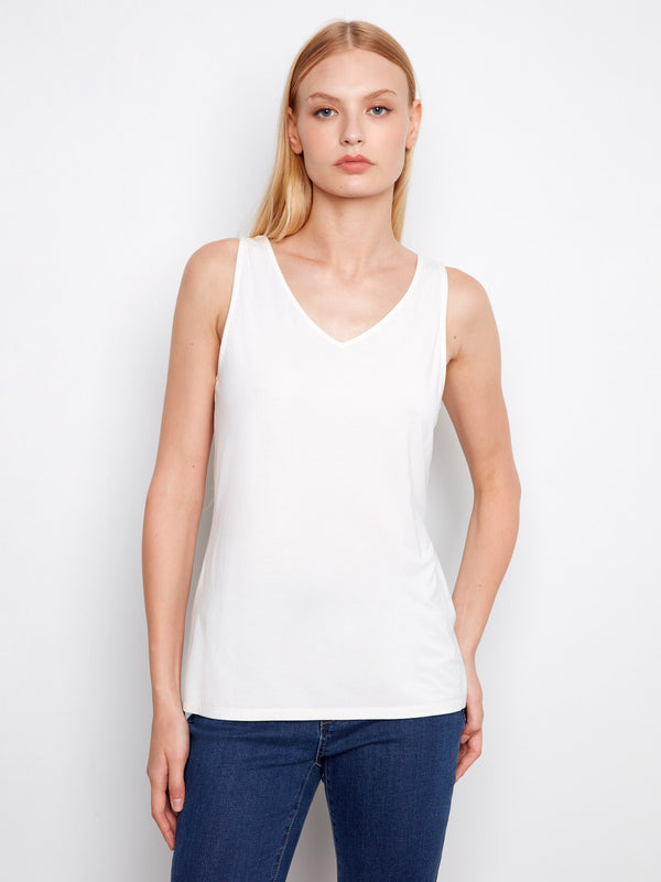 Elegant white top featuring a V-neck, highlighting its relaxed fit and comfortable wear by Charlie B.