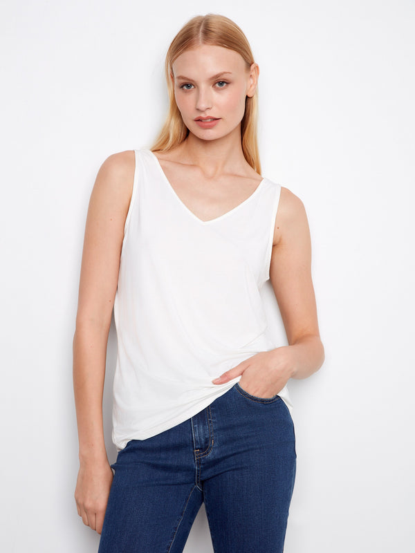 This elegant V-neck white tank is designed to offer both versatility and ease of wear with its unique features. Expertly crafted by Charlie B.