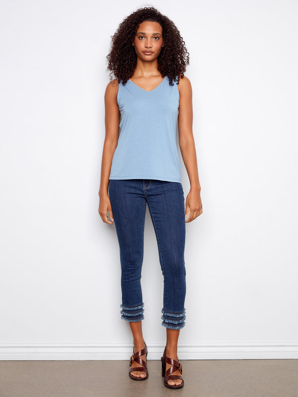 Elegant light blue top with a reversible design, offering both scoop neck and V-neck options. By Charlie B.