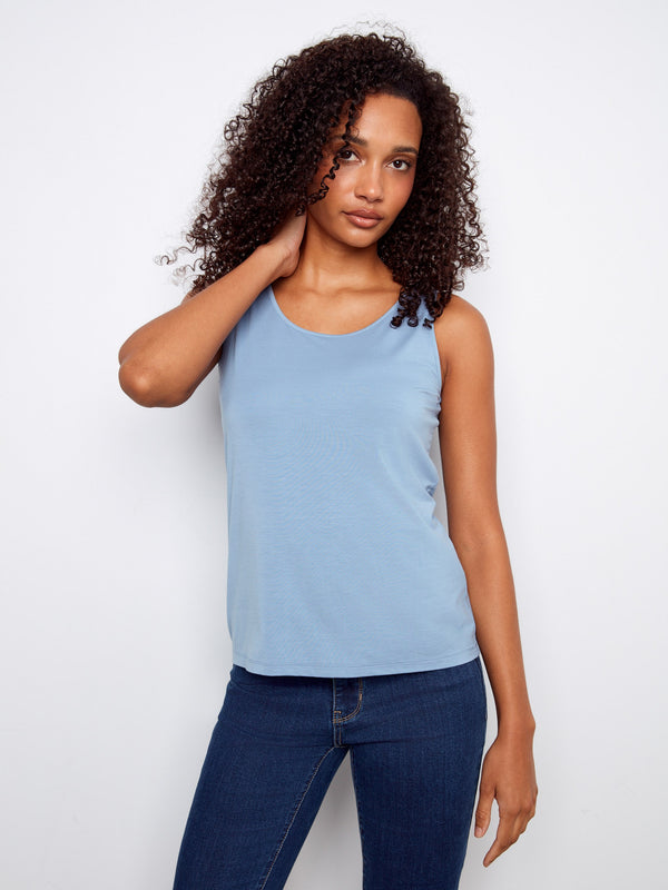 Versatile light blue tank with V-neck, combining style and comfort in its relaxed fit design. By Charlie B.