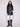 Black quilted vest showcasing a reversible design and practical button front closure by Charlie B.