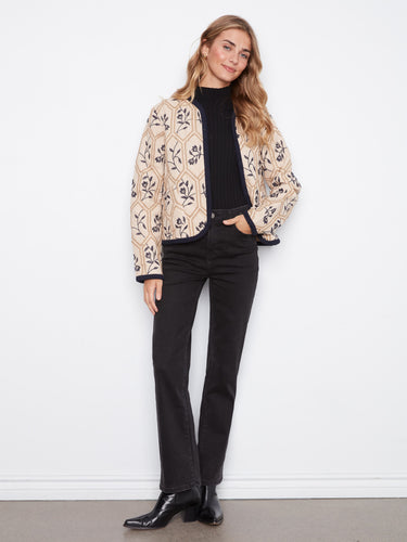 Stylish quilted jacket featuring elegant edge binding for a refined look. A creation by Charlie B.