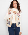 Sleeveless vest with crew neck and floral embroidered sherpa side, perfect for versatile styling by Charlie B.