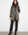 Green quilted puffer jacket featuring patch pockets and a sleek button closure by Charlie B.