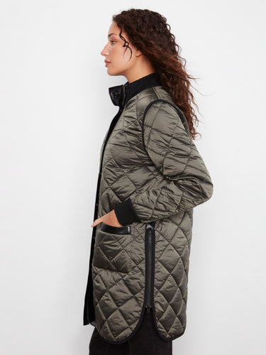 Mocha quilted jacket highlighted with stylish side zippers for versatile wear by Charlie B.