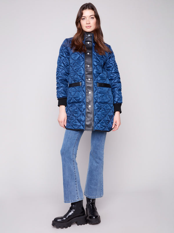 Navy quilted puffer jacket featuring rib knit detailing and snap button closure, perfect for chilly days by Charlie B.