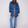 Navy quilted puffer jacket featuring rib knit detailing and snap button closure, perfect for chilly days by Charlie B.