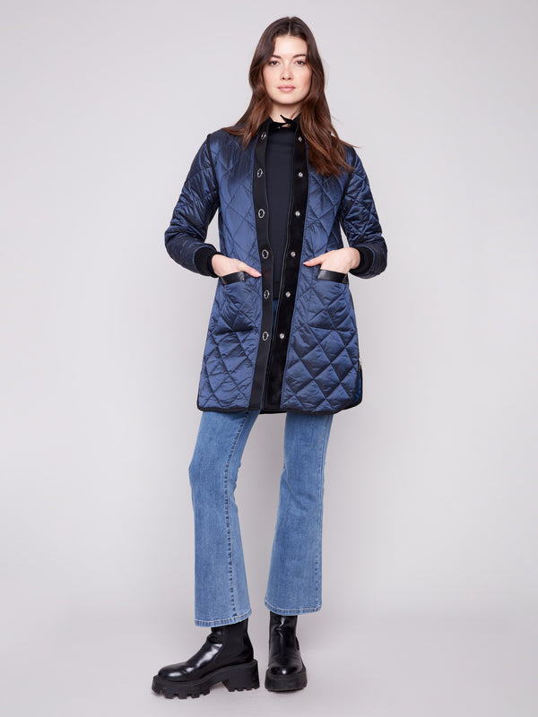Stylish navy quilted jacket with faux leather detailing, adding a touch of elegance to your winter wardrobe by Charlie B.