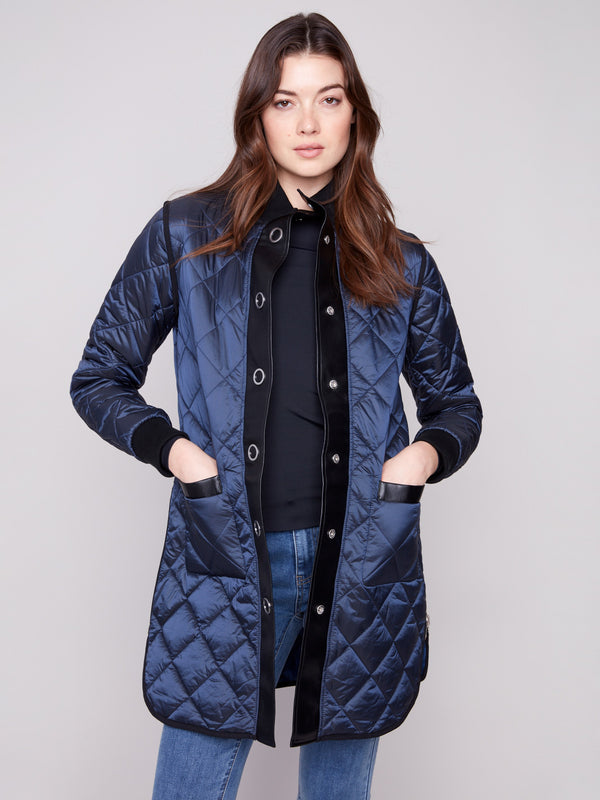 Reversible navy puffer jacket with side zipper details and snap buttons front for versatile styling options by Charlie B.