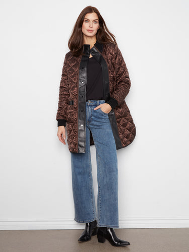 This elegant quilted jacket offers a reversible design, adding versatility to your wardrobe by Charlie B.