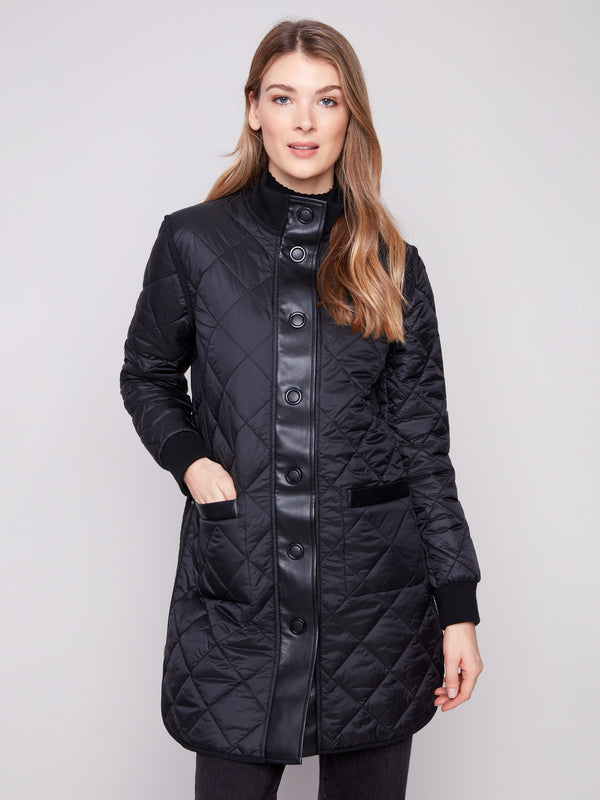 Reversible quilted black jacket with side zipper details and snap button closure, ideal for versatile styling by Charlie B.
