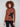 Mock neck sweater showcasing a bold leaf motif on a warm brown background by Charlie B.
