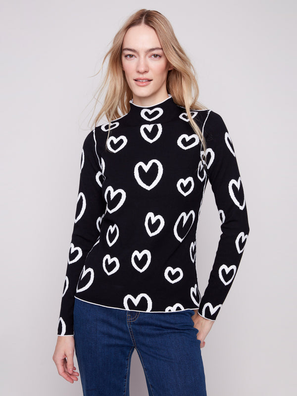 Chic reversible sweater featuring a striking black and white heart motif by Charlie B.