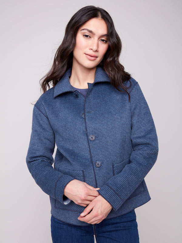 The button front closure enhances the sophisticated appeal of this reversible plaid jacket by Charlie B.