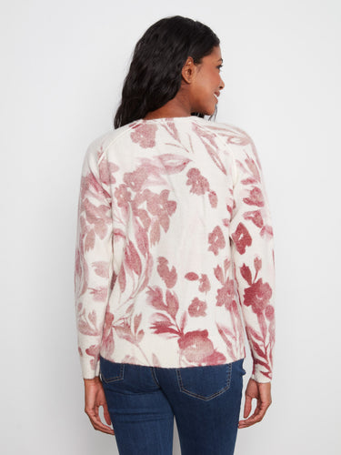 Floral print adds charm to this comfortable sweater featuring long raglan sleeves by Charlie B.