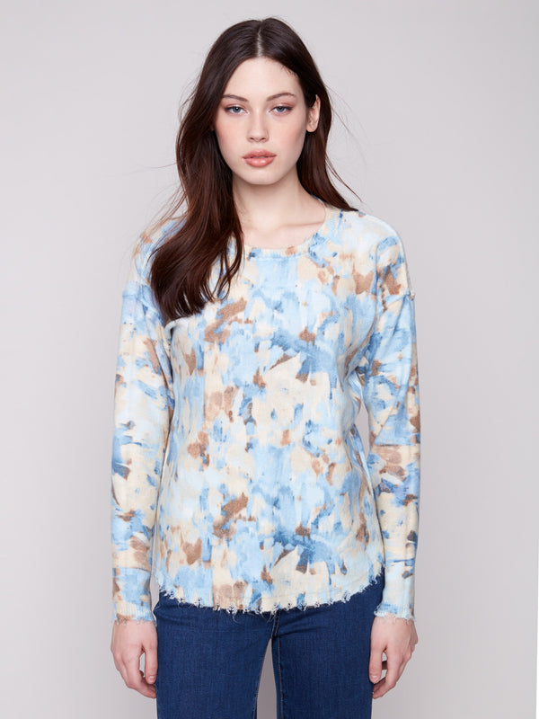 Experience comfort with the plush texture of this vapor-colored sweater, enhanced by its unique abstract print by Charlie B.