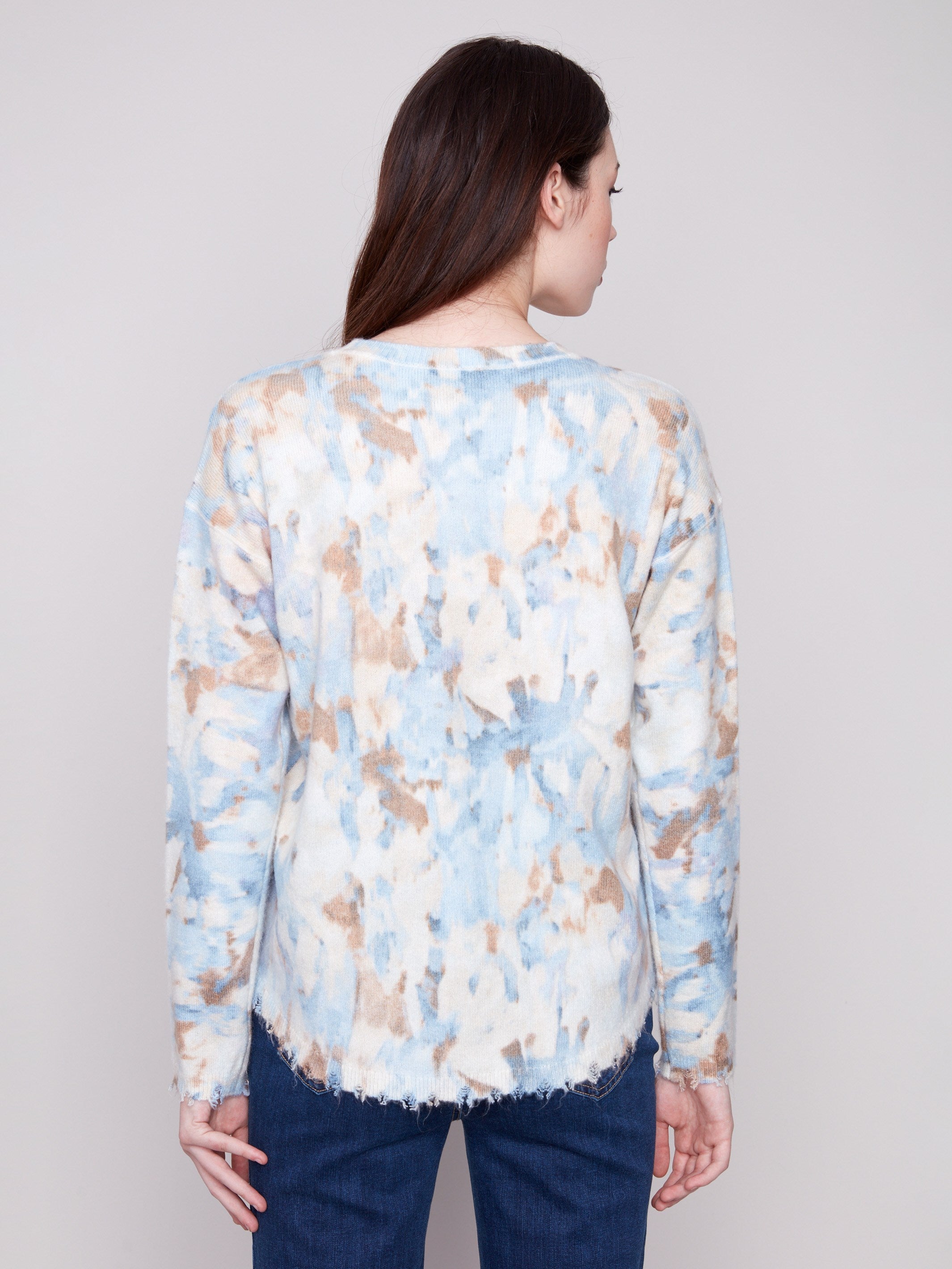 Drop shoulders design adds a relaxed vibe to this abstract printed sweater with frayed edges for an edgy finish by Charlie B.