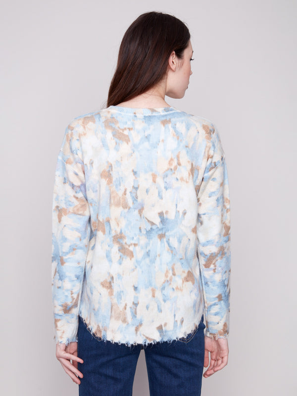 Drop shoulders design adds a relaxed vibe to this abstract printed sweater with frayed edges for an edgy finish by Charlie B.