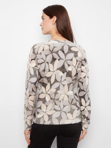 Floral pattern in soft pastels on this sweater, offering both comfort and style with its drop shoulders by Charlie B.