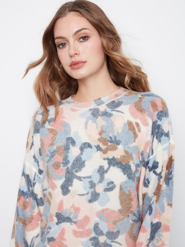 The crew neck detail adds a classic touch to this colorful floral sweater, making it perfect for layering. By Charlie B.