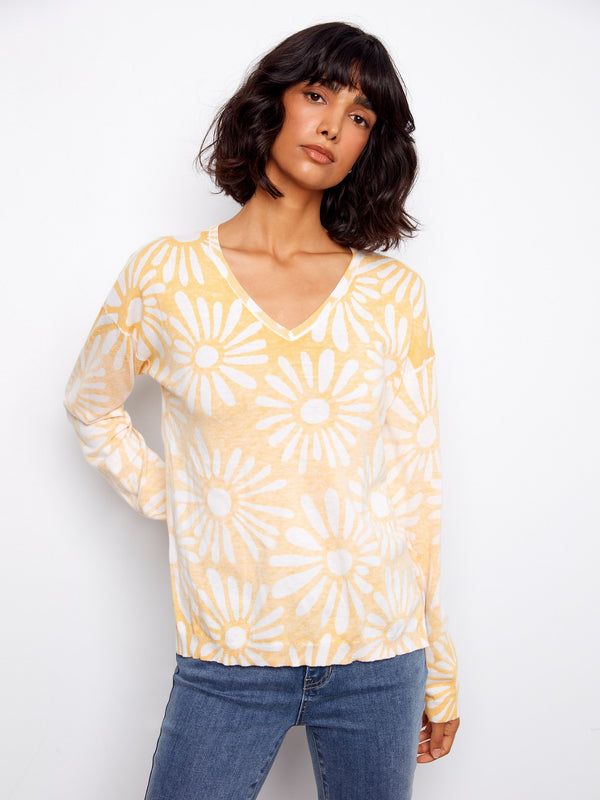 Versatile top with an elegant V-neck and eye-catching print, perfect for layering or wearing solo on mild days. Made by Charlie B.