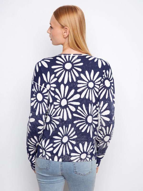 Navy blue reversible sweater with eye-catching floral graphics, adding flair to your wardrobe staples by Charlie B.