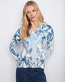 This stylish top features a V-neck design in a cotton blend, offering both comfort and fashion. By Charlie B.