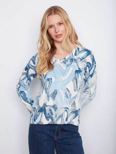 This stylish top features a V-neck design in a cotton blend, offering both comfort and fashion. By Charlie B.