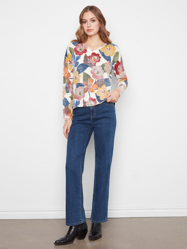 Embrace relaxed fashion with drop shoulders on this floral sweater. The vibrant colors enhance any casual look by Charlie B.