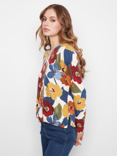 Show off your style with the unique reversible print of this cozy V-neck sweater. A must-have addition to any wardrobe by Charlie B.