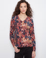 Floral V-neck top with a reversible print, showcasing vibrant colors and a relaxed fit. By Charlie B.