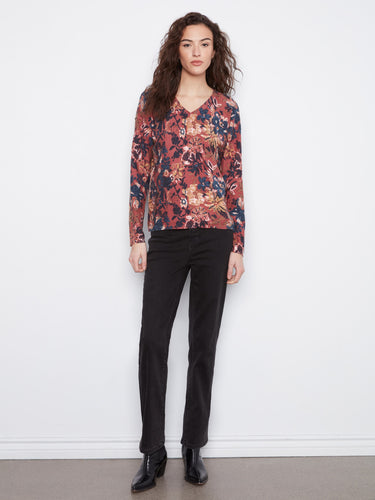 Elegant long-sleeve blouse featuring a unique floral pattern, perfect for layering or wearing alone. By Charlie B.