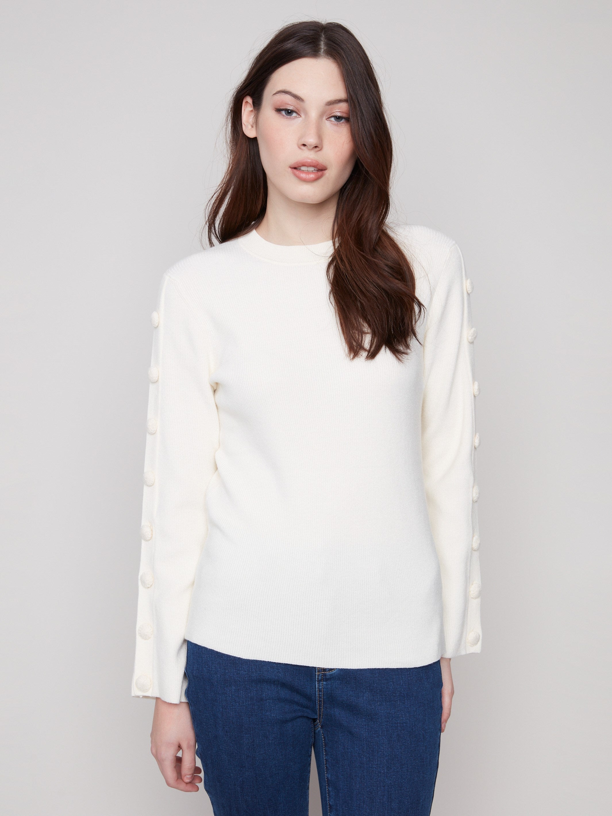 Ecru ribbed sweater showcasing a classic crew neck style, perfect for layering or wearing alone by Charlie B.