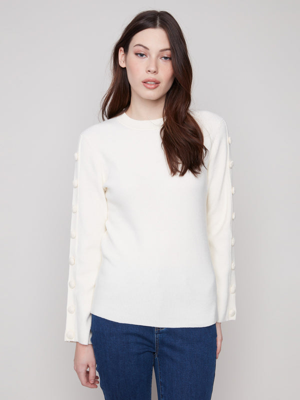 Ecru ribbed sweater showcasing a classic crew neck style, perfect for layering or wearing alone by Charlie B.