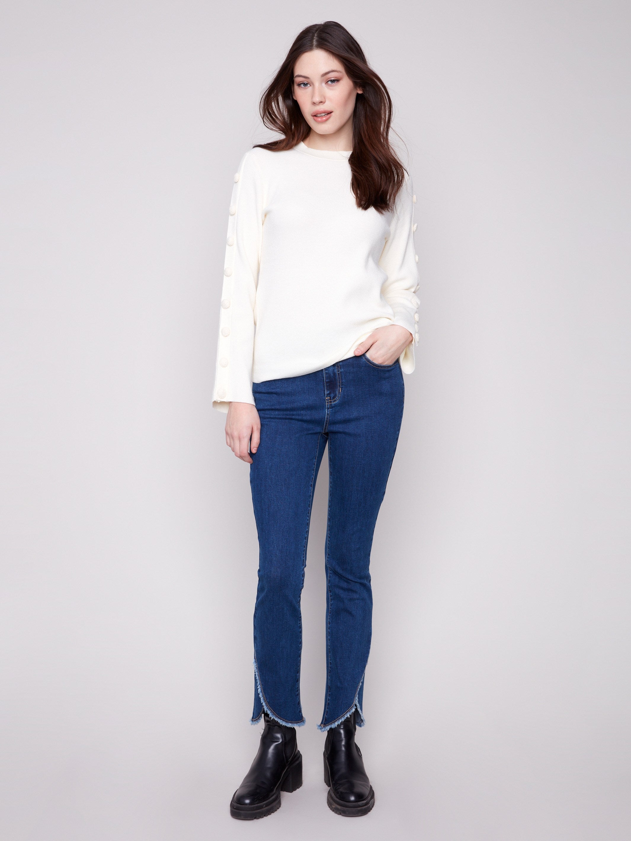 Stylish ecru sweater featuring button details on the sleeves, adding a touch of elegance by Charlie B.
