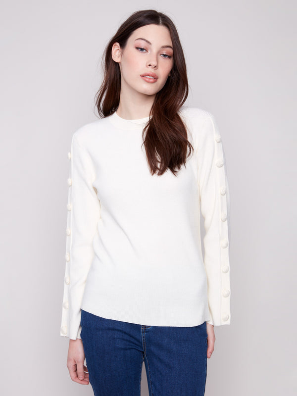 Elegant ecru sweater with intricate button embellishments along the sleeves for added flair by Charlie B.