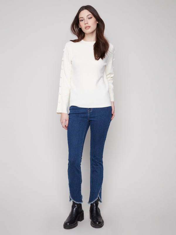 Versatile crew neck sweater in ecru with a chic ribbed texture, ideal for casual or dressy looks by Charlie B.