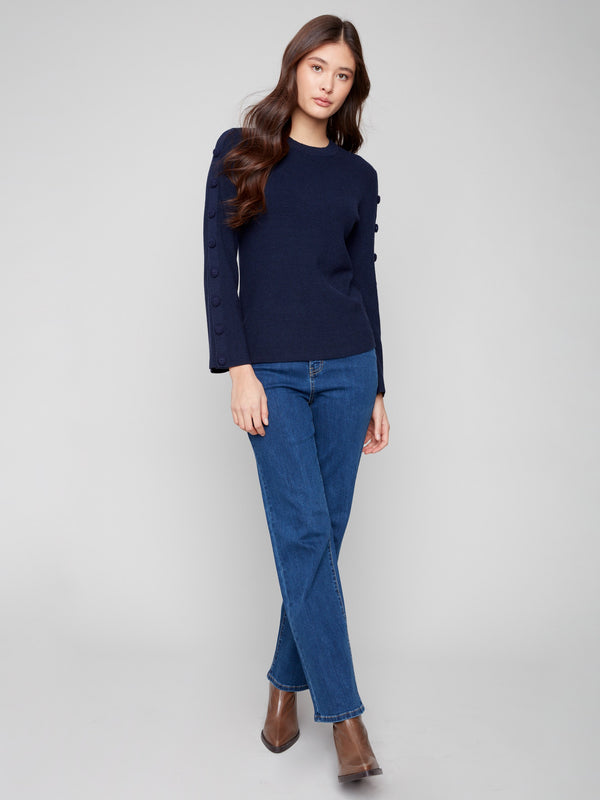 Elegant navy sweater with detailed buttons along the sleeves, adding a touch of sophistication to your outfit by Charlie B.
