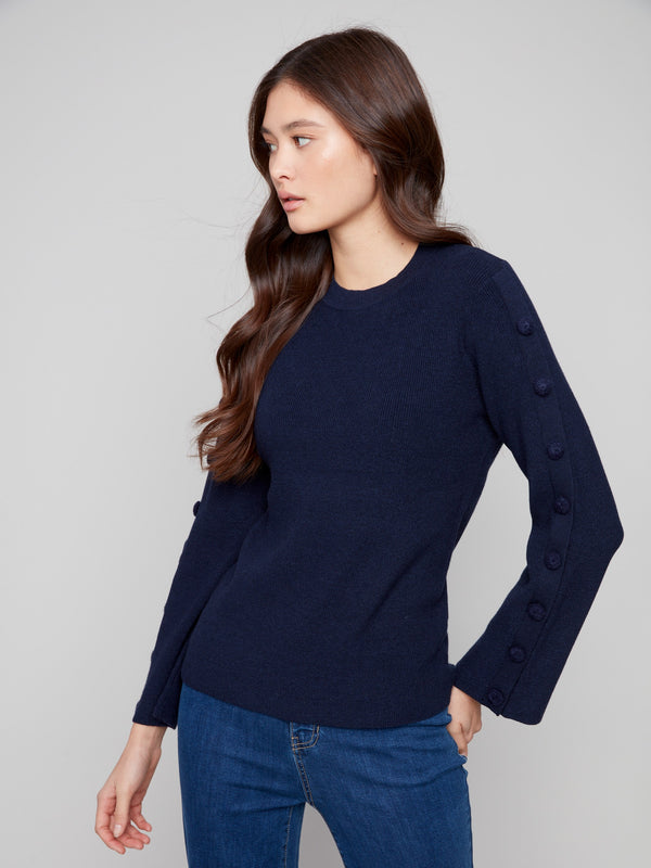 Ribbed navy sweater designed with attention to detail, showcasing stylish button accents on the sleeves for added flair by Charlie B.