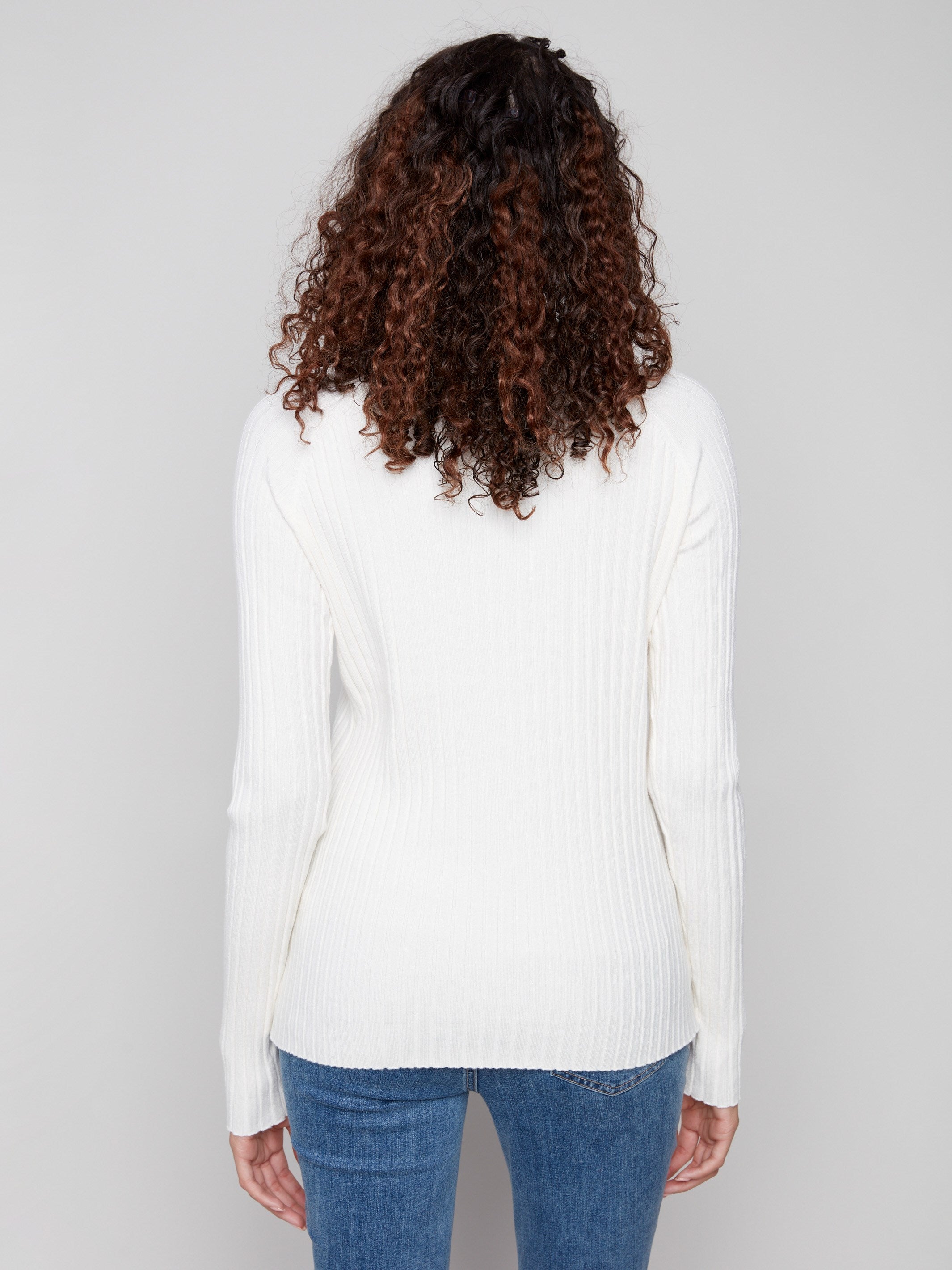This ecru mock neck sweater offers a timeless look with its ribbed detailing by Charlie B.