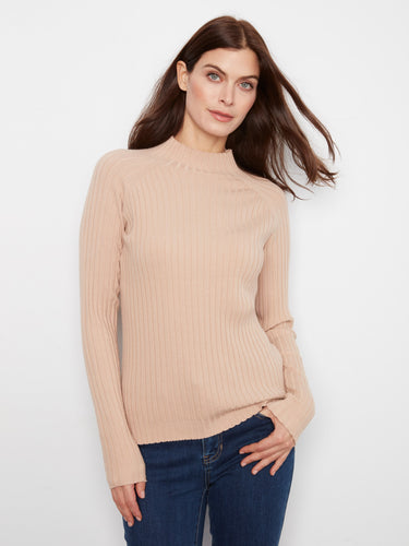 Embrace the ribbed knit texture of this chic beige sweater, offering both warmth and timeless style. By Charlie B.