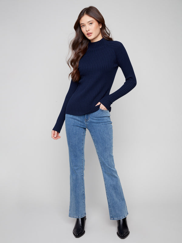 Navy sweater with a slim fit, perfect for layering in cooler weather by Charlie B.