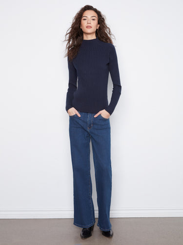 Elegant slim fit navy sweater featuring long sleeves for a flattering silhouette. Crafted by Charlie B.
