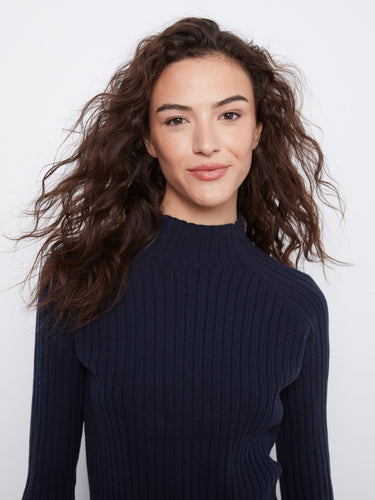 Stylish mock neck enhances the modern appeal of this navy sweater, adding elegance to any outfit. By Charlie B.