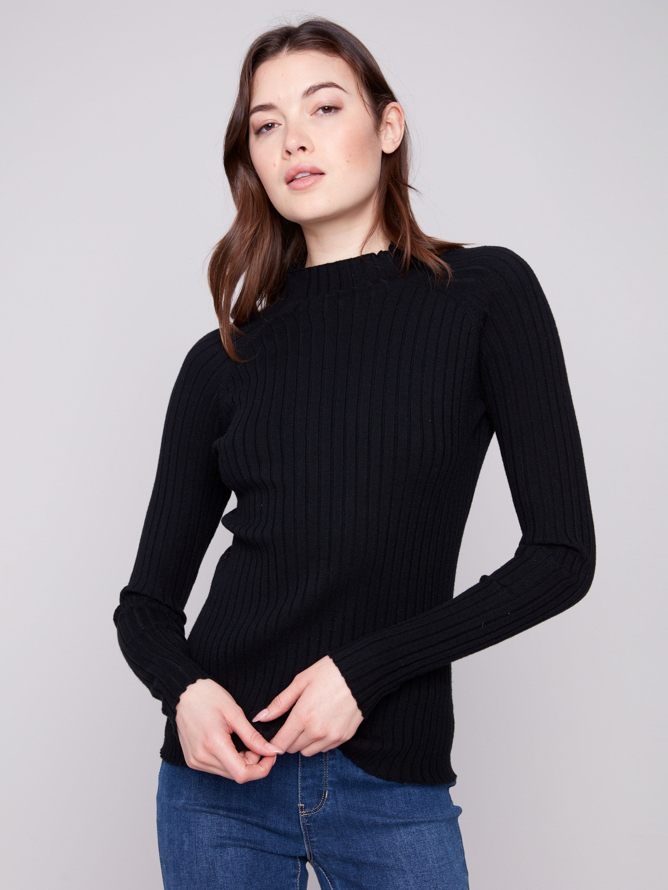 Black ribbed knit sweater featuring a chic mock neck design, perfect for versatile styling by Charlie B.