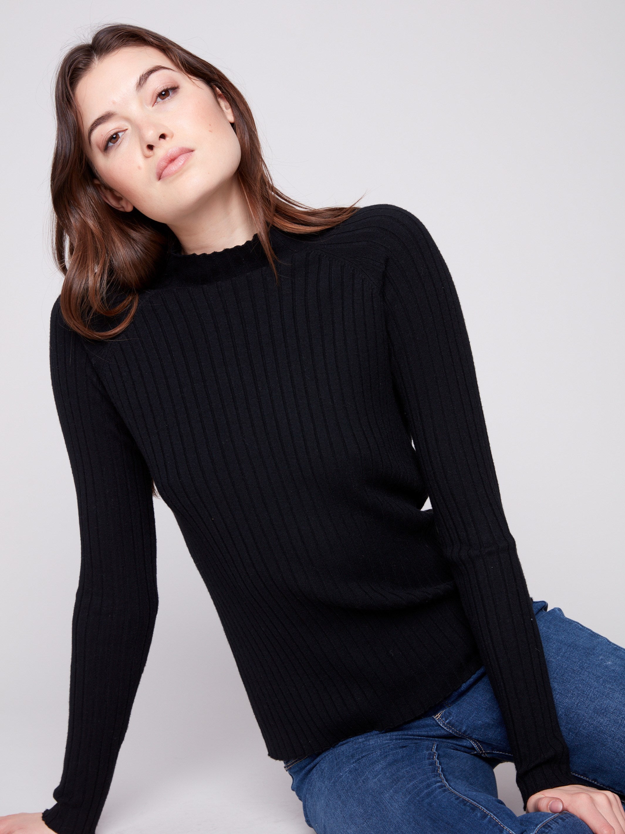 Elegant black sweater with a slim fit silhouette and ribbed texture, ideal for layering by Charlie B.