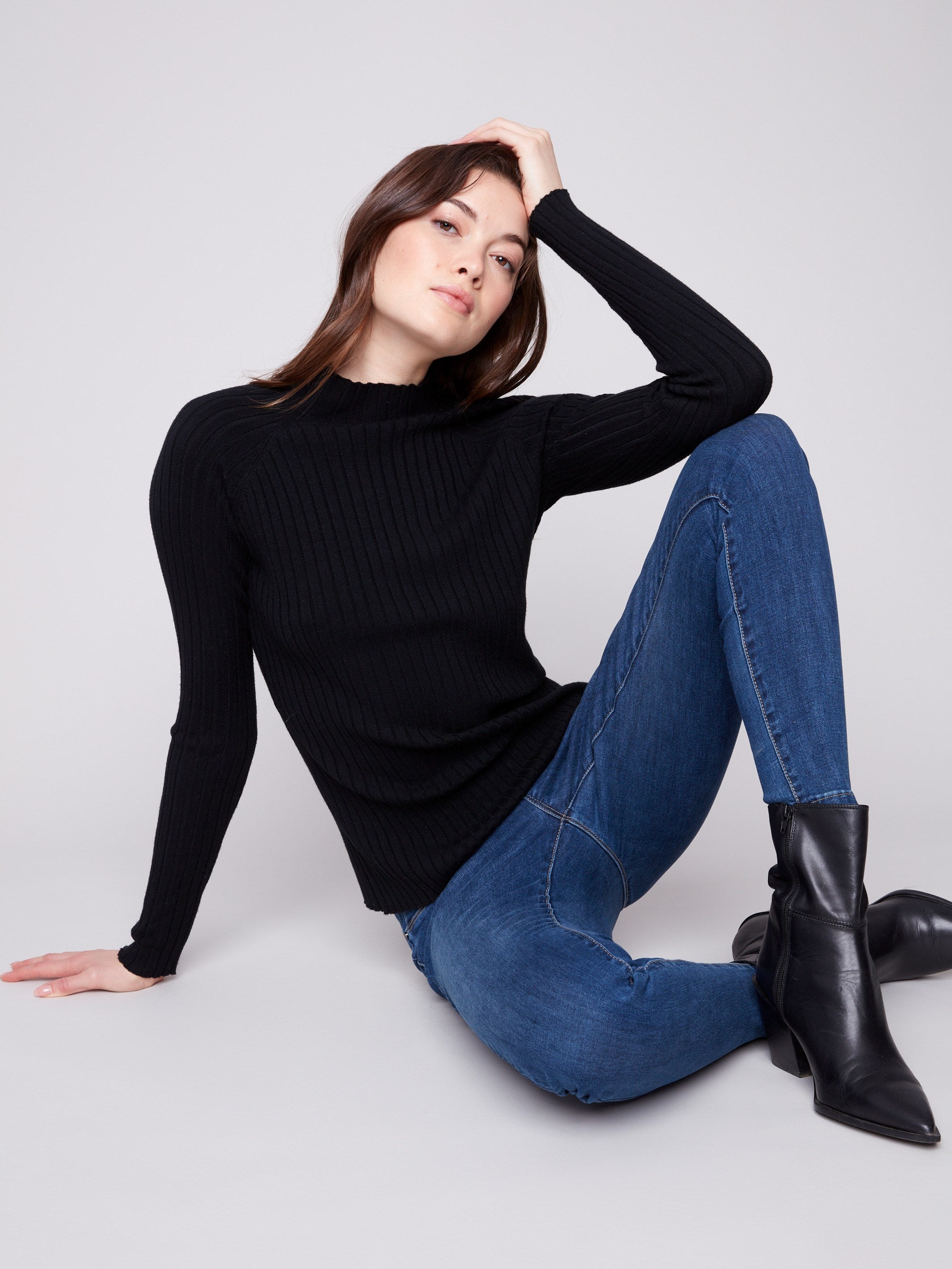 Ribbed knit black sweater showcasing sophisticated long sleeves and modern style by Charlie B.