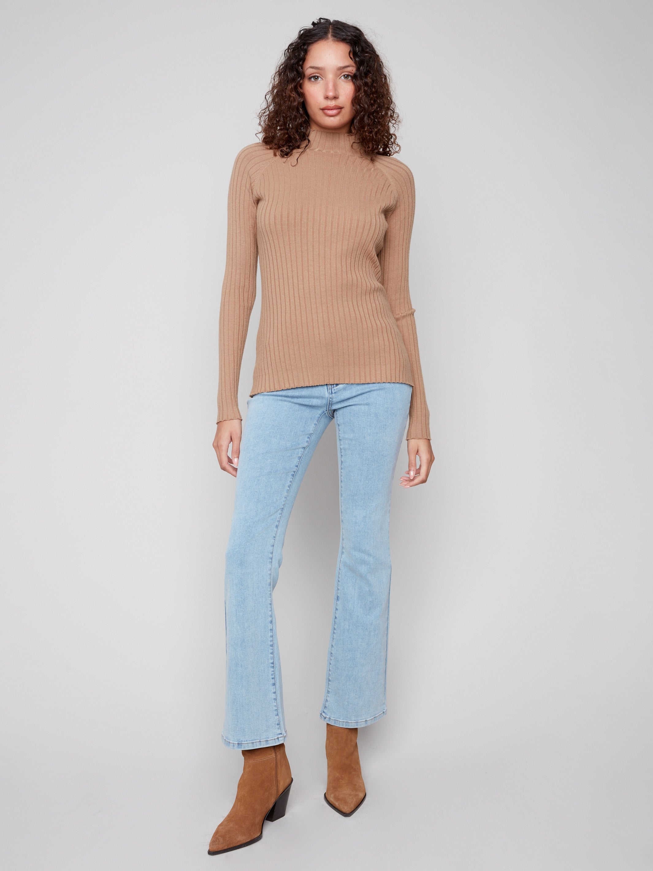This slim fit truffle sweater offers a flattering silhouette with its ribbed knit texture by Charlie B.