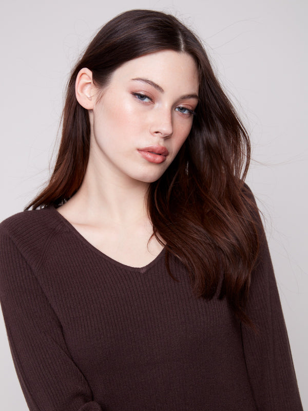 Stylish V-neck mocha sweater accentuated with intricate heart rivets on the sleeves by Charlie B.